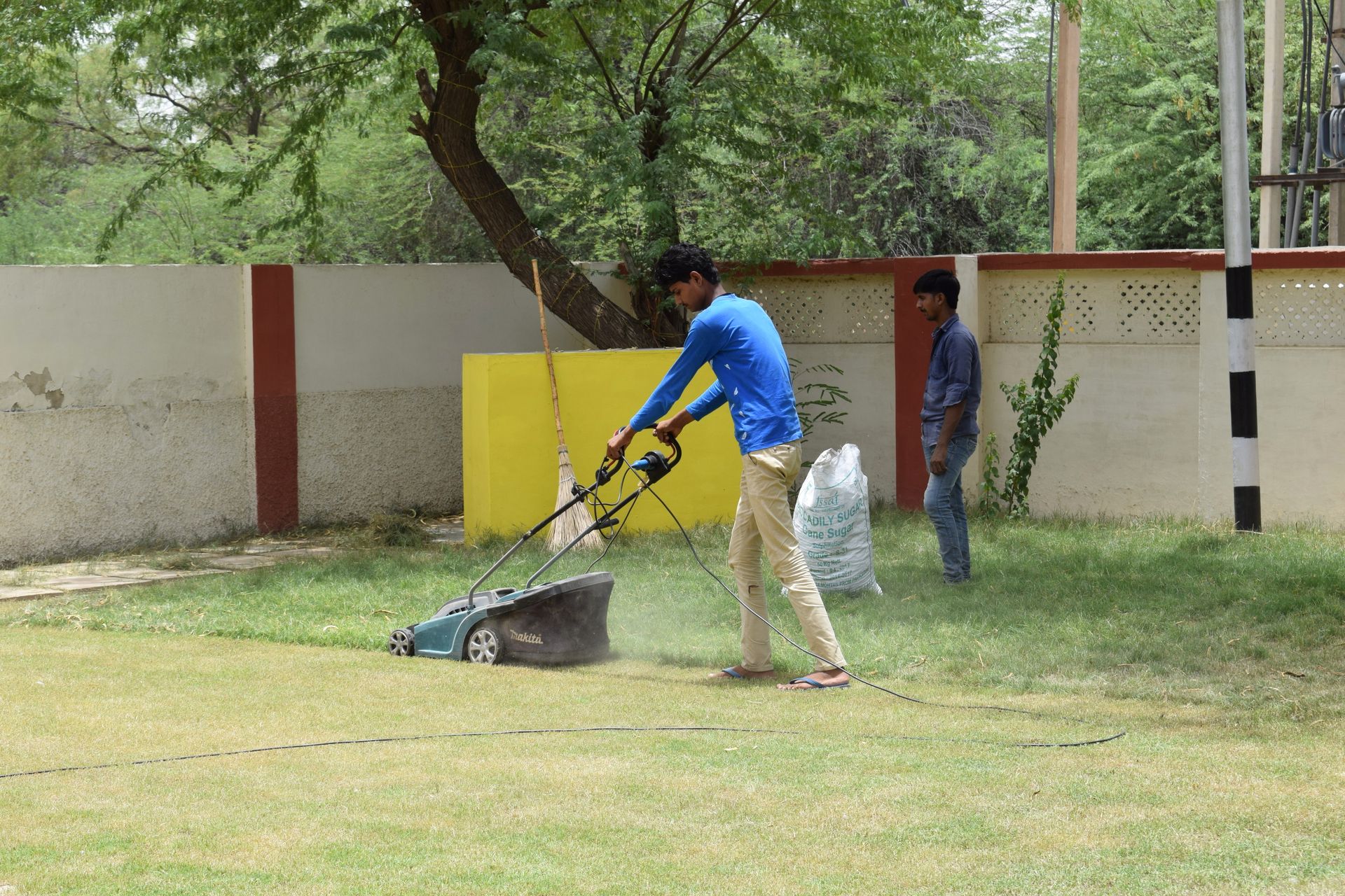 Lawn crew mowing a property together